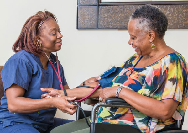 Nurse Taking Woman's Blood Pressure