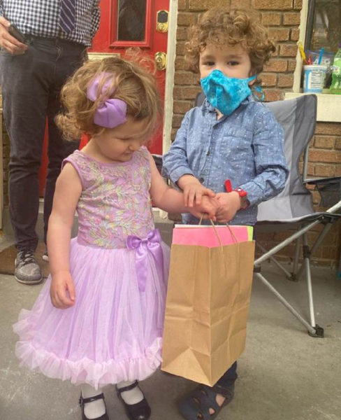 Chase and Estella hold a bag of Easter cards